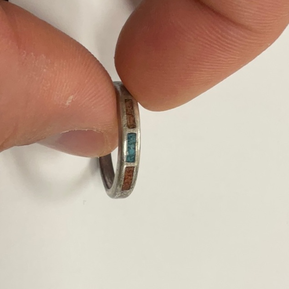 Silver colored vintage ring with turquoise and brown colored stones.